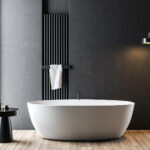 Dark gray bathroom with white tub